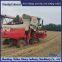 Modification of wheat harvester with triangular track wheels to prevent slipping on muddy ground