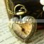 Cutting transparent glass heart shaped old pocket watch
