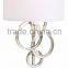 1017-1 sleek brushed steel finish raindrops falling on a calm body of water intertwining Circles Plug-In Wall Sconce