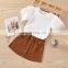 2020 Hot Sale New Creative Pure White Feather Sleeve T-shirt + Metal Button Corduroy Short Skirt Set