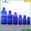 blue essential oil glass bottle with silver dropper