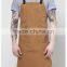 Brown canvas work apron with crossback straps