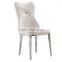 Concaved headrest dinning chair with white glossy PU covering and iron legs