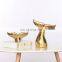 ceramic artwork of golden whale tail ornaments
