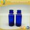 1/2 oz blue glass boston round bottle with black phenolic cap