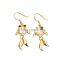features a large crystal and two black microset crystals 18K gold earring