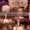 Centerpiece flower arrangement with white orchids cascading over the side, dripping crystal beads and roses
