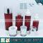 Red coloured cosmetic glass pump bottles and glass cream jars