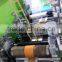 Slitting and rewinding rotary label die cutting machine