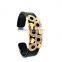 featuring gold plated detail and loop design open bangle