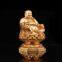 The golden happy buddha stuatue is seated in a double lotus base show his smiling and big belly