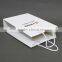 White paperboard bags with handles