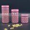 pink metal cover clear glass canister