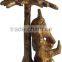 brass ganesha under tree