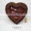 heart-shaped dark brown moss and sisal pot