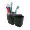 Black toothbrush holder toothbrush and toothpaste inside