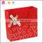 Coated art paper brand logo with ribbon decorate fancy paper bag with plastic handles