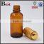 30ml round shoulder pharmaceutical amber glass serum bottle with gold press pump