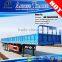 Tri-axis 40ft flat bed cargo transporting side breast board trailer truck with container locks