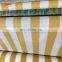 yellow and white strip shade net fence