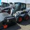 Bobcat skid steer loader with bucket sweeper attachments