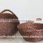 Small round rattan basket with handles
