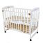 White adjustable baby cot with wiggler