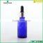 blue essential oil glass bottle with silver dropper