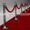 red and white rope red carpet and stands