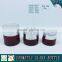 Red coloured cosmetic glass pump bottles and glass cream jars
