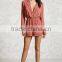 Lady Woven surplice neckline notched lapels an elasticized waist long sleeves a center-back pleat and contrast piping romper