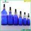 blue essential oil glass bottle with silver dropper