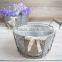 round metal flower pot stand with wooden heart button and ribbon