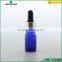 blue essential oil glass bottle with silver dropper