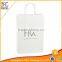 Custom White paper gift bags with die cut ribbon handles