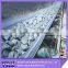 Abrasion resistant rubber conveyor belt with full guage skims between plies