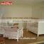 wooden convertible crib with a large storage drawer