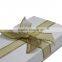 White elegant gift put it in a box tie it with a ribbon