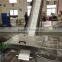 Incline belt conveyor with hopper and discharge chute