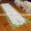 embroidered table runner with shamrock designs on satin material