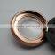 Empty compact powder container with metallic finish