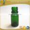 green essential oil glass bottle with silver glass pipette