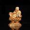 The golden happy buddha stuatue is seated in a double lotus base show his smiling and big belly