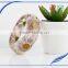 Pine needles inside transparent clear acrylic bangle stand