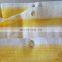 yellow and white strip shade net fence
