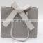 Boutique shop grey paper shoping gift bag with your own embossed silver logo