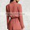 Lady Woven surplice neckline notched lapels an elasticized waist long sleeves a center-back pleat and contrast piping romper
