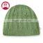 Different kinds of green knit beanie hats