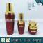 Red coloured glass cosmetic oil bottle and cream glass jars
