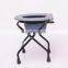 Elderly pregnant woman folding bath chair with commode